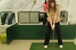 Young Female Practicing Golf Swing