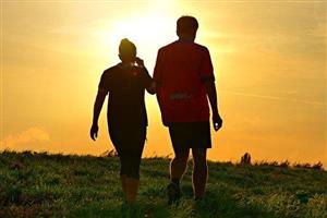 Man and woman hiking in the sunrise